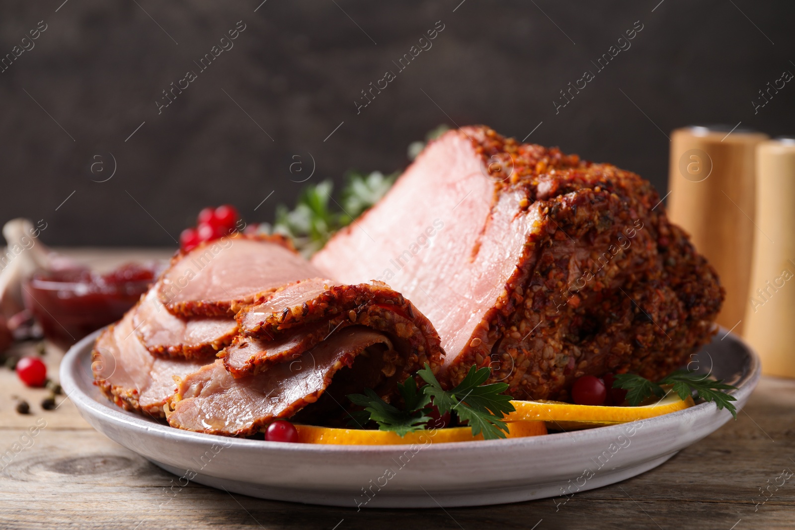 Photo of Delicious ham served with garnish on wooden table