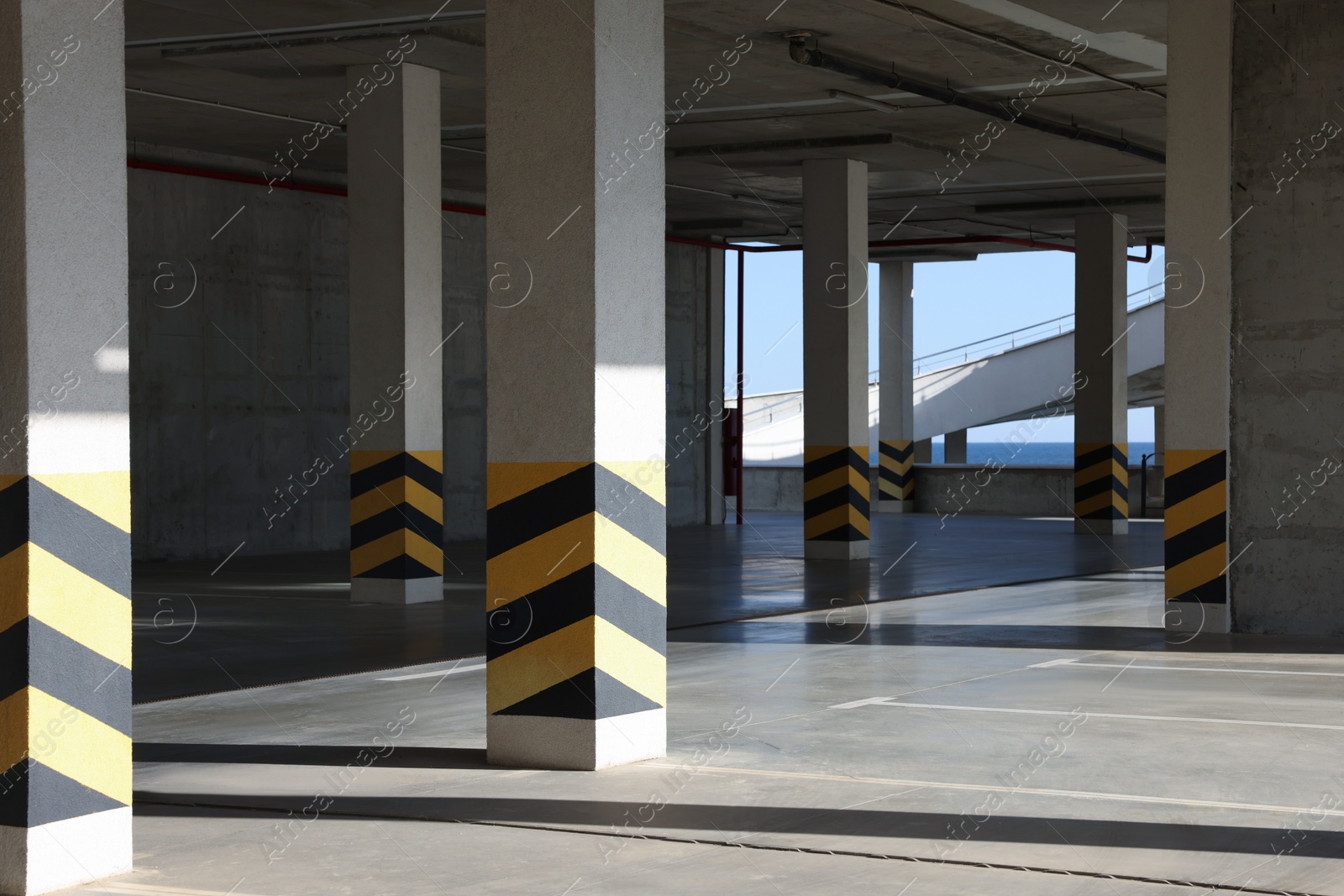 Photo of Empty open car parking garage on sunny day