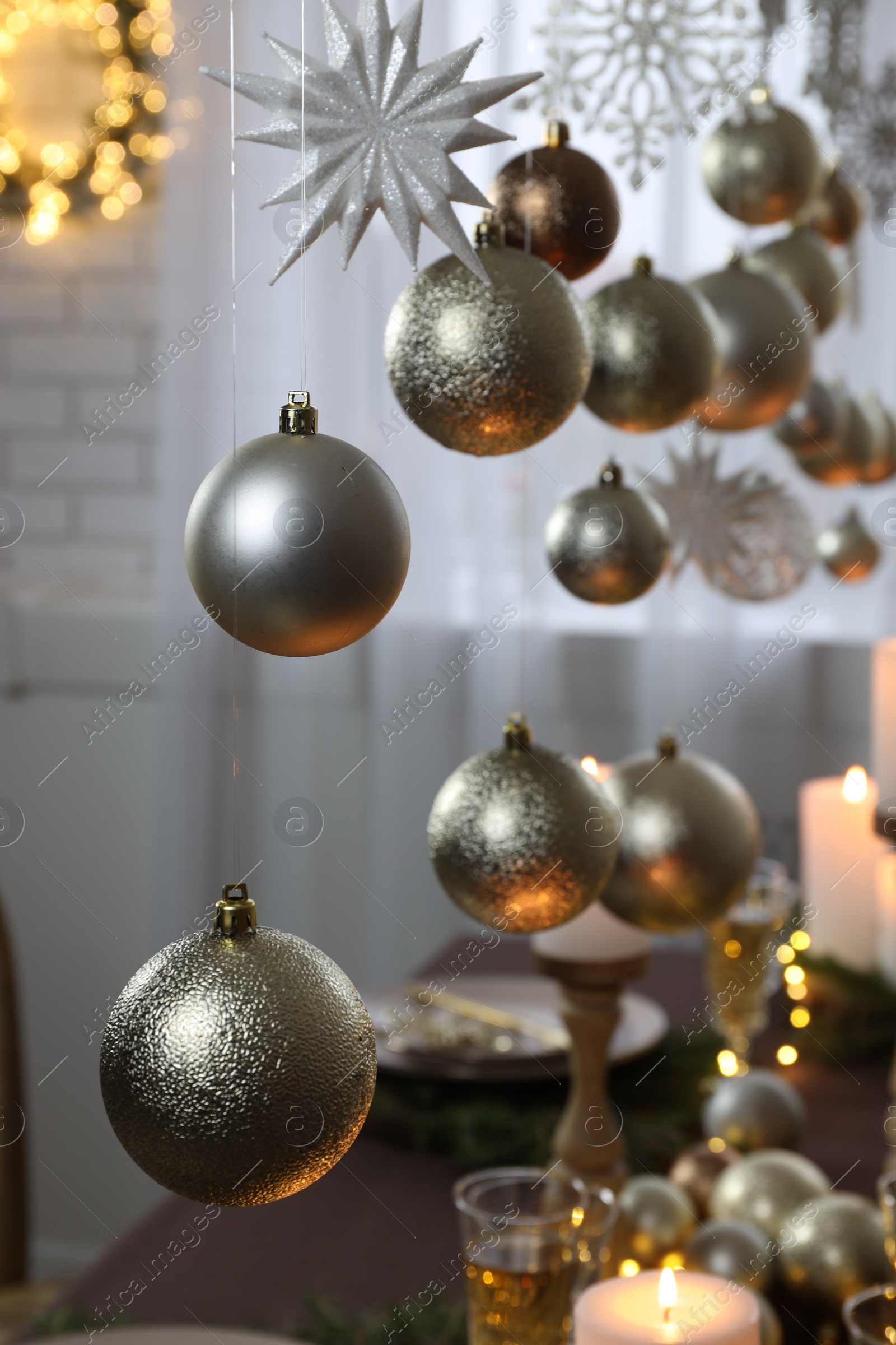 Photo of Beautiful Christmas decor hanging over table indoors