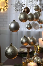 Photo of Beautiful Christmas decor hanging over table indoors