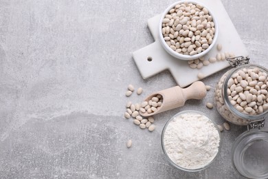 Photo of Bean flour and seeds on light grey table, flat lay. Space for text