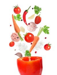 Image of Stuffed pepper recipe. Fresh ingredients falling into bell pepper on white background