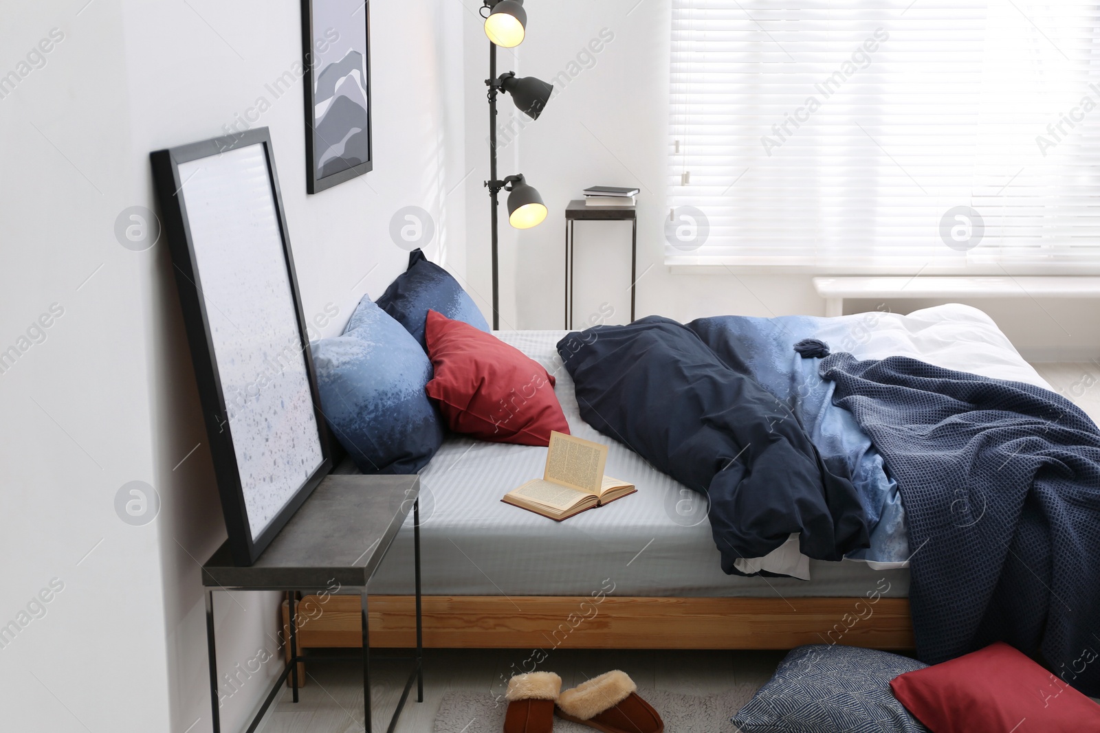 Photo of Comfortable bed with stylish linens in room