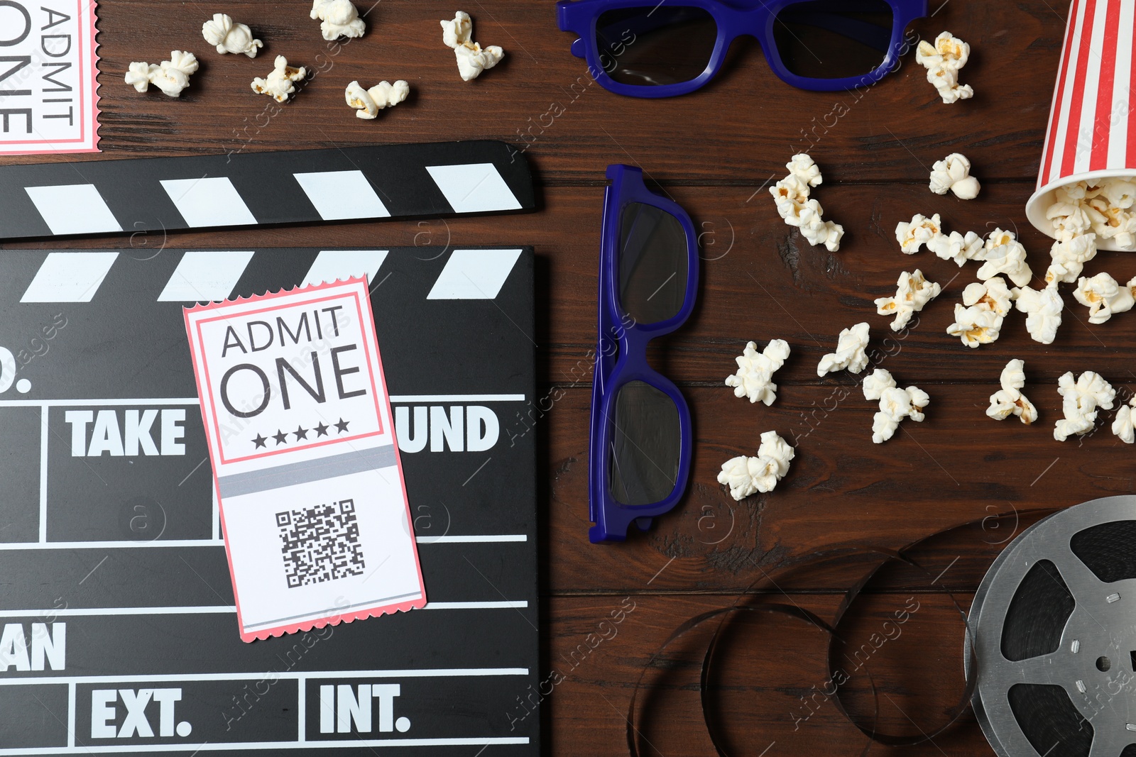 Photo of Flat lay composition with clapperboard, cinema tickets and 3d glasses on wooden table