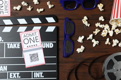 Photo of Flat lay composition with clapperboard, cinema tickets and 3d glasses on wooden table