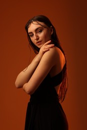 Portrait of beautiful woman on brown background