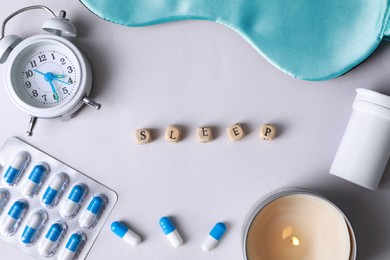 Photo of Flat lay composition with word Sleep made of cubes on white background. Insomnia treatment