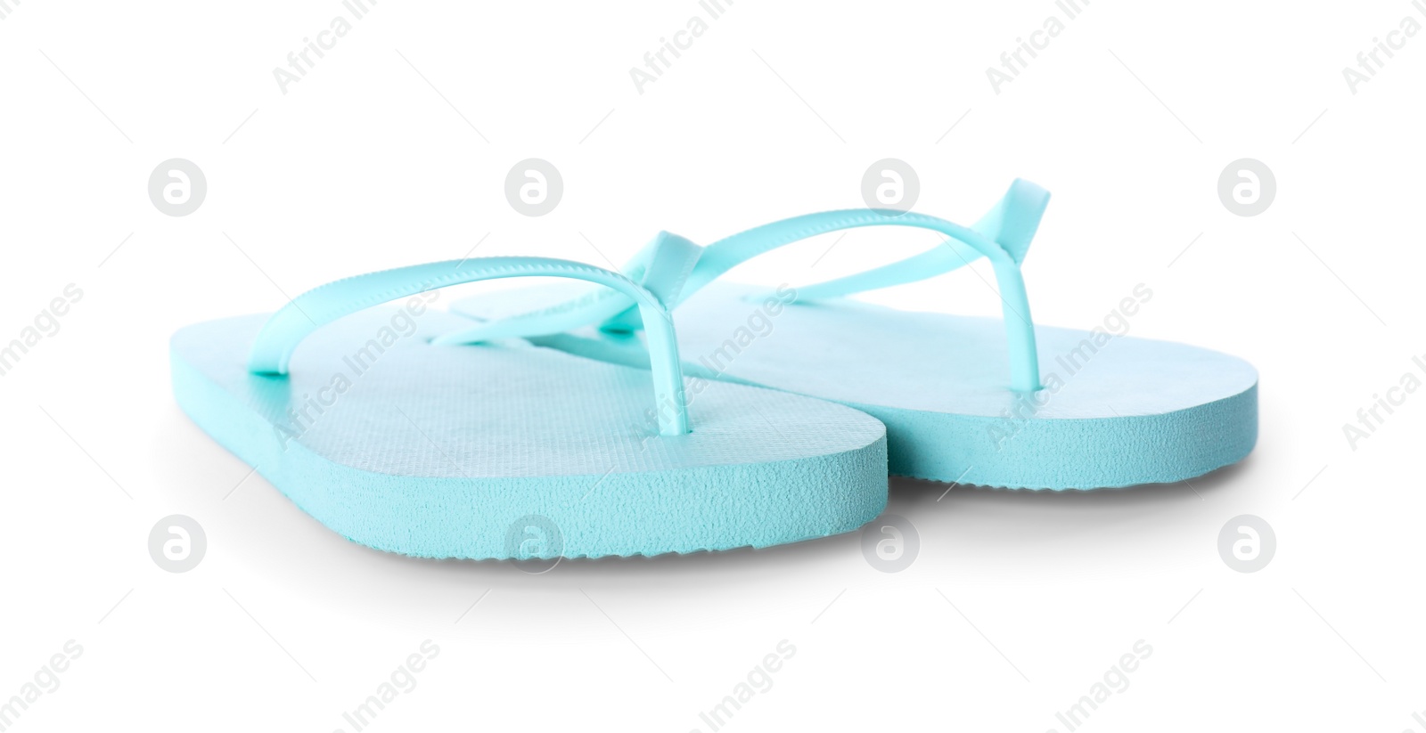 Photo of Light blue flip flops isolated on white. Beach accessory