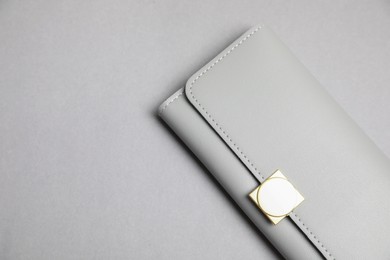 Photo of Stylish leather purse on light grey background, top view. Space for text
