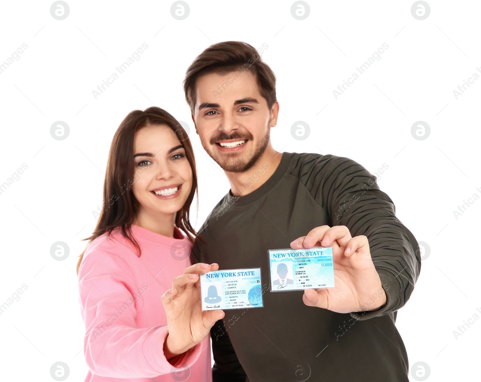 Photo of Happy young people with driving licenses on white background