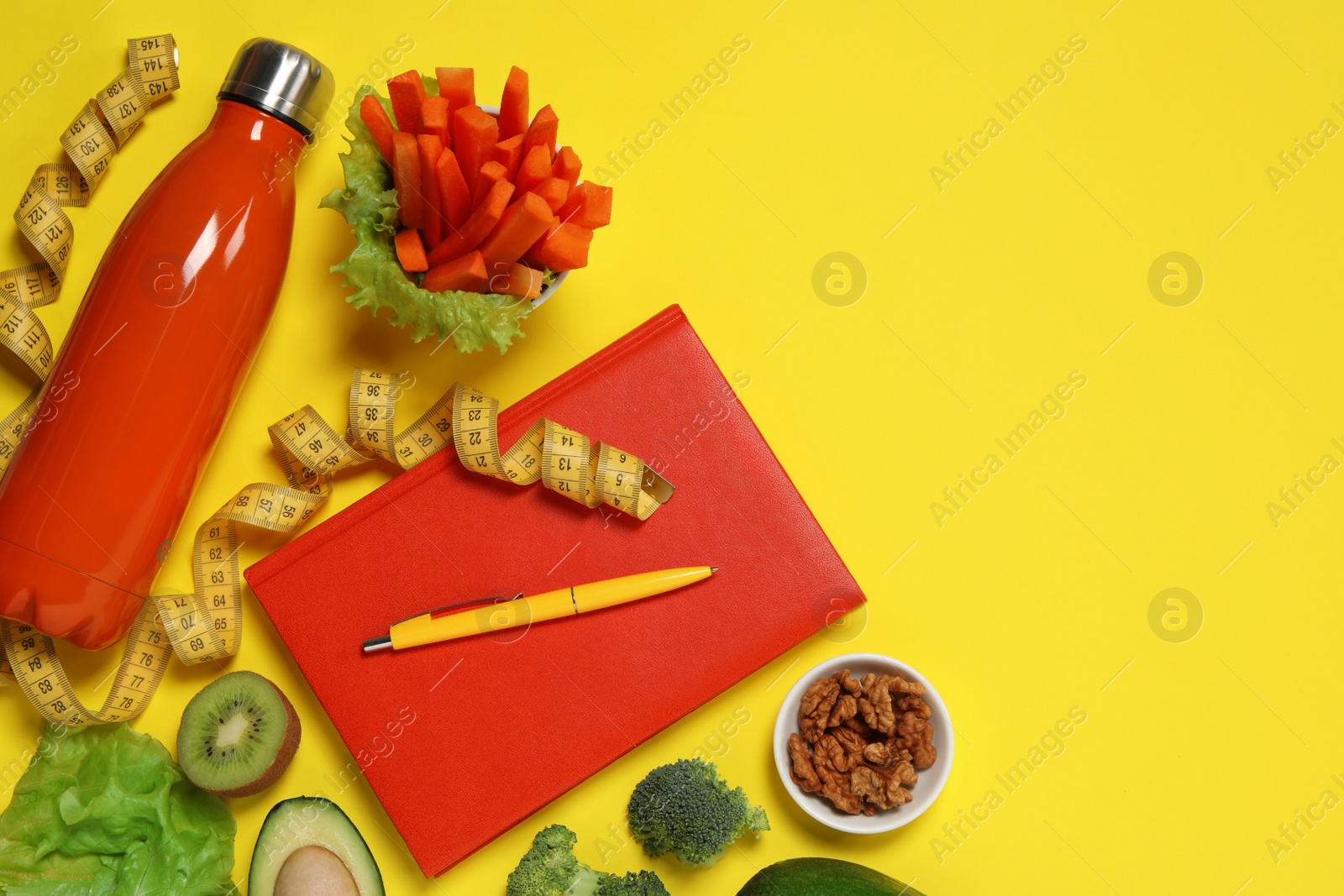 Photo of Weight loss concept. Flat lay composition with notebook, thermo bottle, measuring tape and different products on yellow background, space for text