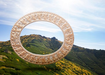 Image of Vintage frame and beautiful mountains under blue sky with clouds