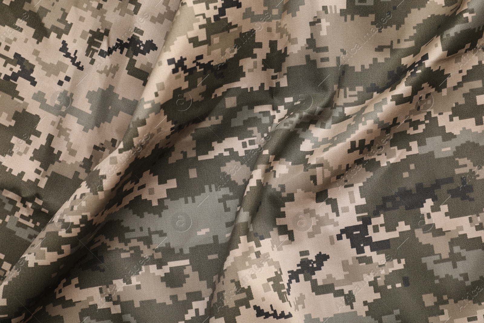 Photo of Texture of crumpled camouflage fabric as background, top view