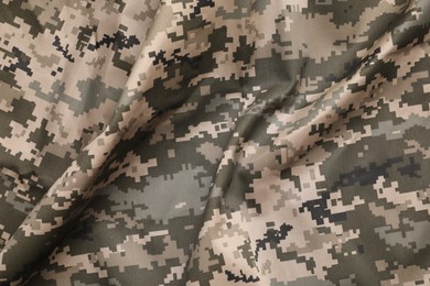 Texture of crumpled camouflage fabric as background, top view