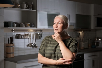 Photo of Mature woman suffering from depression at home