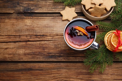 Photo of Flat lay composition with aromatic mulled wine on wooden table, space for text