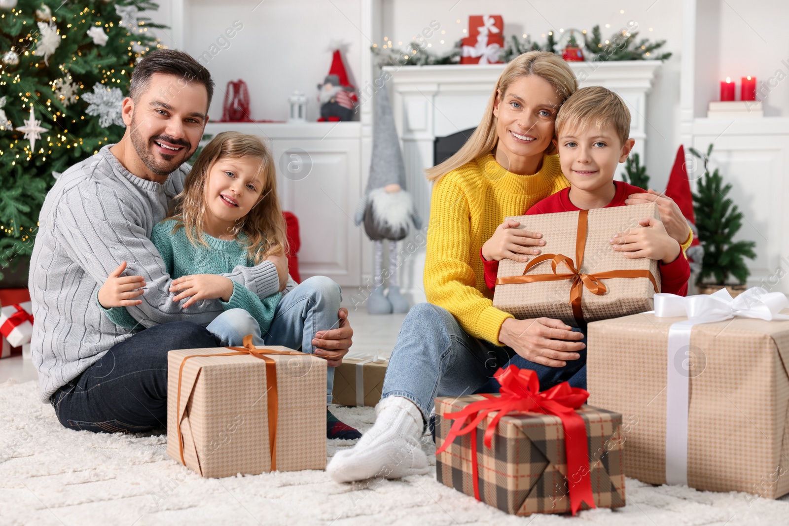 Photo of Happy family with Christmas gifts at home