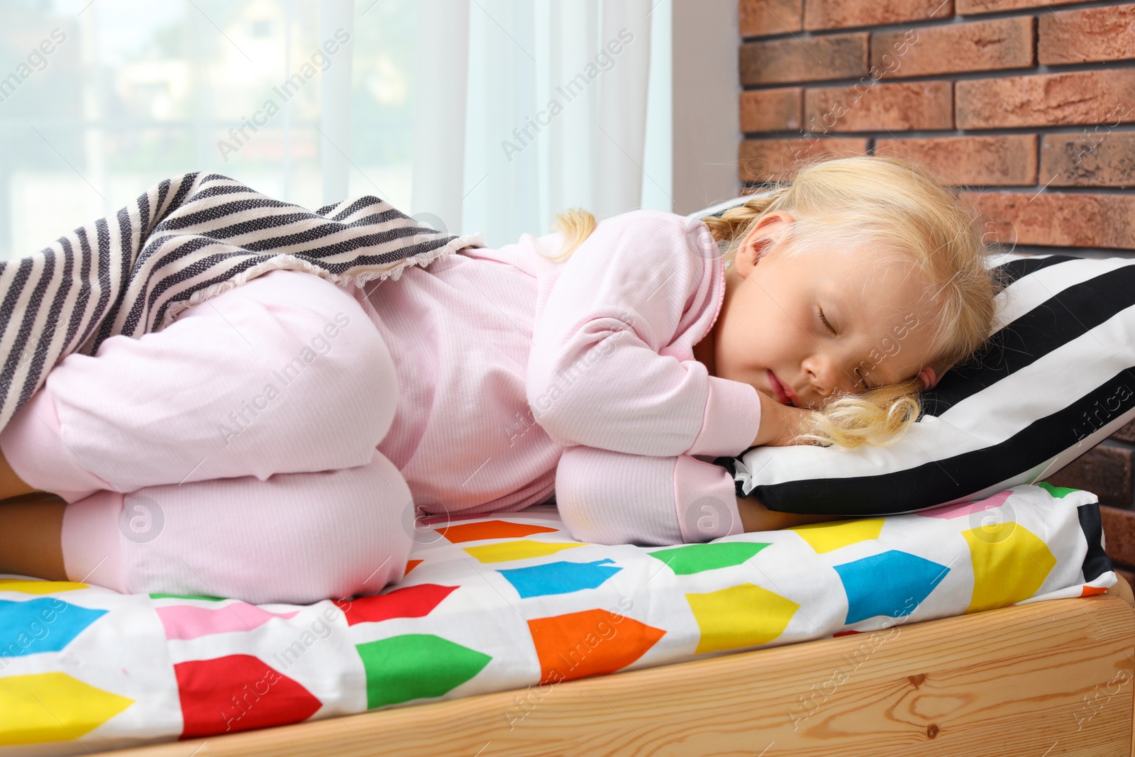 Photo of Cute little girl sleeping in bed at home