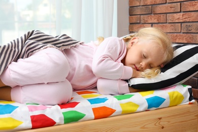 Cute little girl sleeping in bed at home