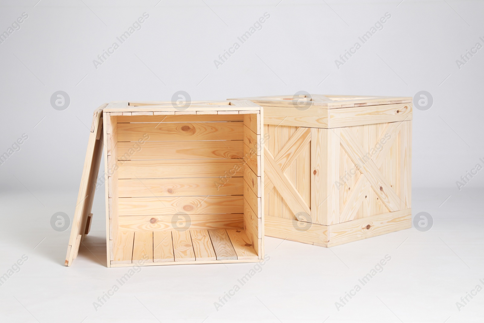 Photo of Pair of wooden crates on grey background