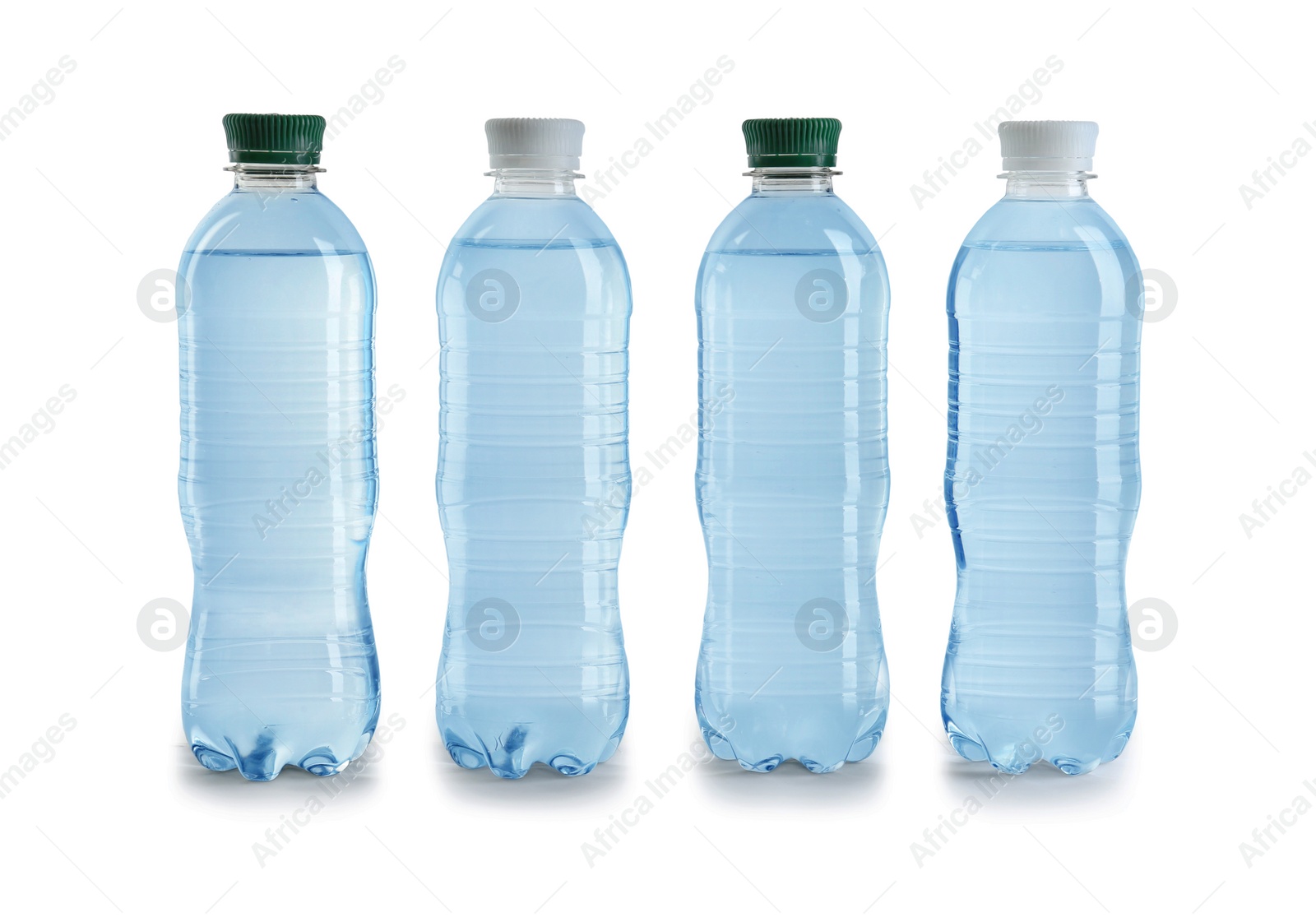 Photo of Row of different plastic bottles with water on white background