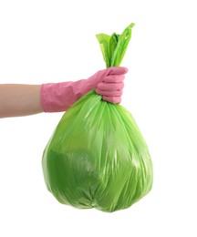 Photo of Woman holding plastic bag full of garbage on white background, closeup