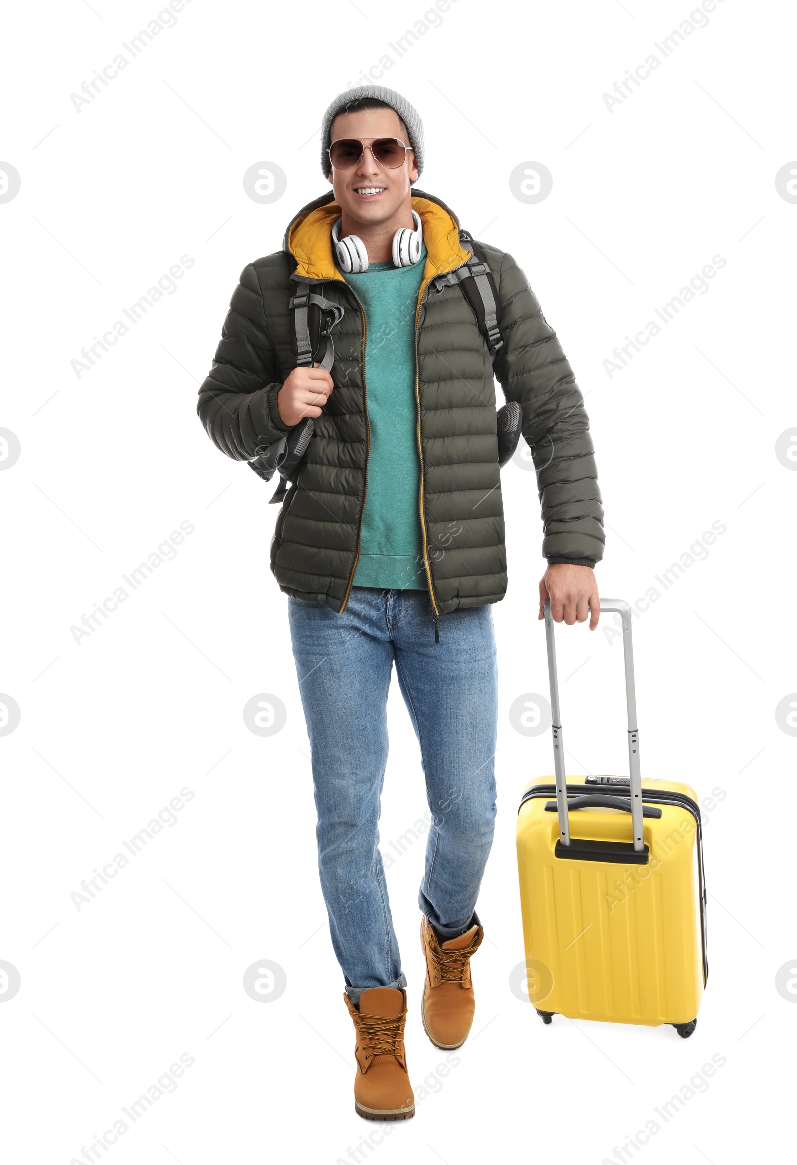 Photo of Man with suitcase walking on white background. Winter travel
