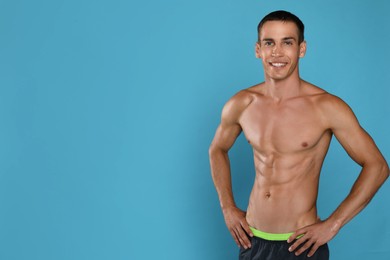Photo of Handsome shirtless man with slim body on light blue background. Space for text