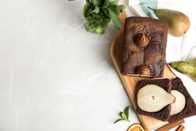 Photo of Flat lay composition with tasty pear bread on light grey marble table, space for text. Homemade cake