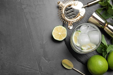 Photo of Cocktail with vodka and lime on grey table, flat lay. Space for text