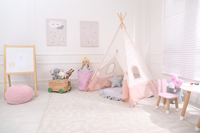 Cute child's room interior with toys, modern furniture and play tent