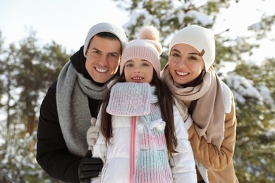 Happy family outdoors on winter day. Christmas vacation