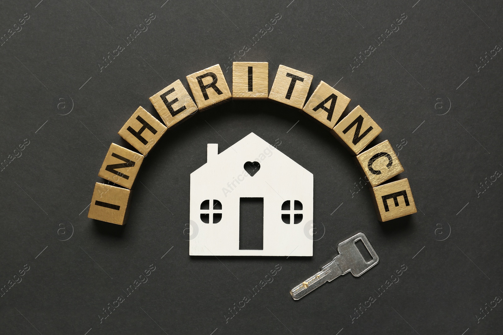 Photo of Word Inheritance made with cubes, house model and key on black background, flat lay