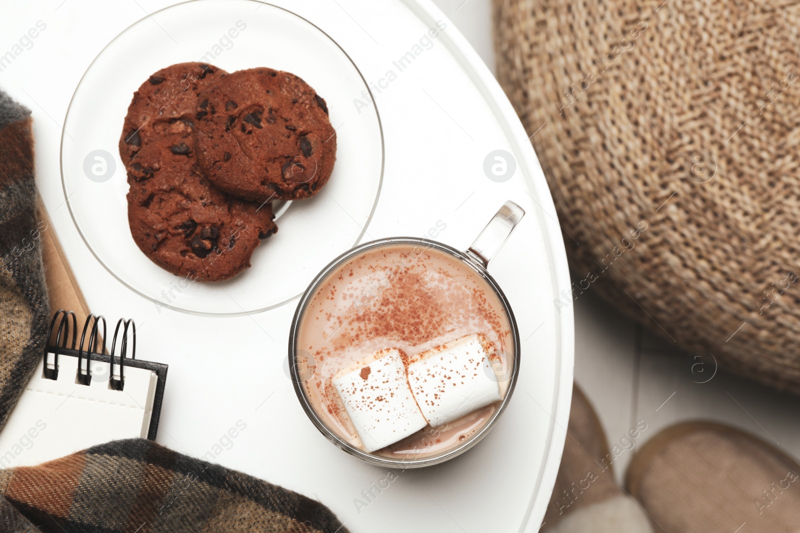 Photo of Cup of delicious hot cocoa with marshmallows and cookies on white table, top view. Winter drink