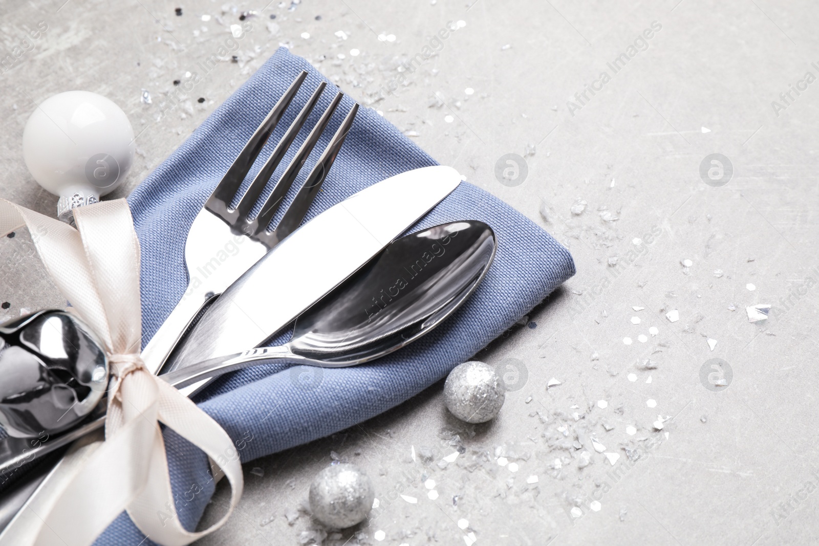 Photo of Cutlery set on grey table, space for text. Christmas celebration