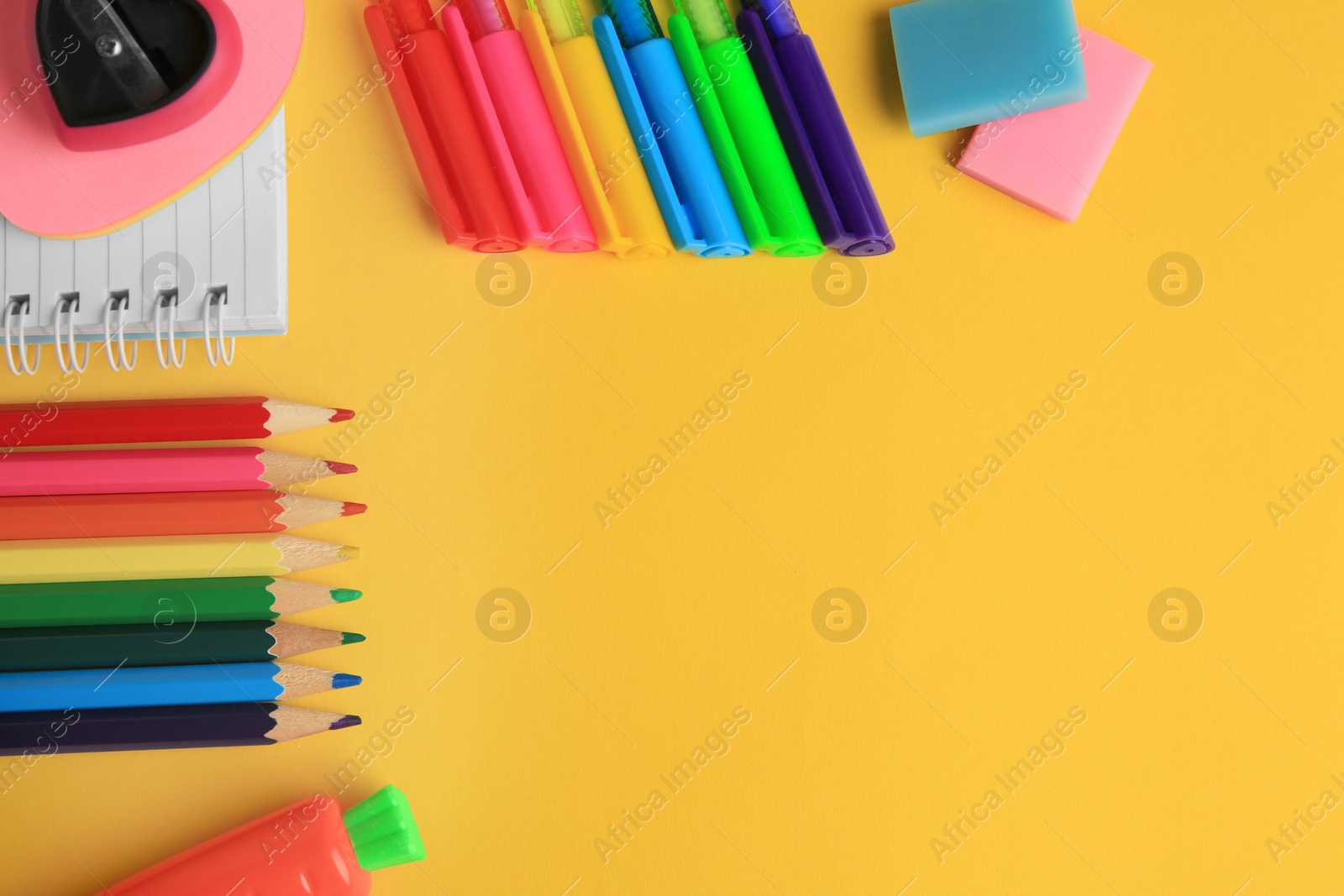 Photo of Flat lay composition with different school stationery on yellow background, space for text. Back to school