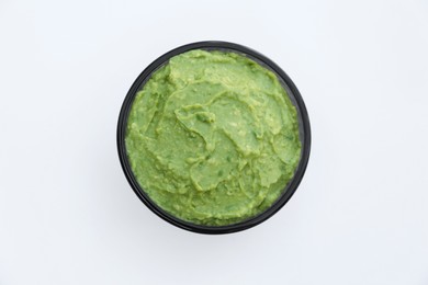 Photo of Delicious guacamole made of avocados on white background, top view