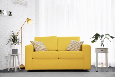 Image of Color of the year 2021. Stylish room interior with yellow sofa