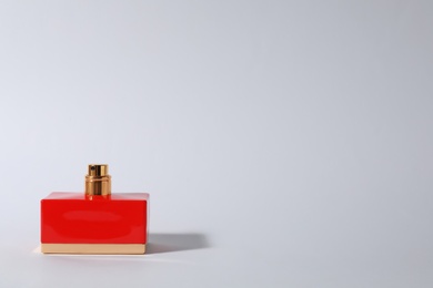 Bottle of perfume on light background