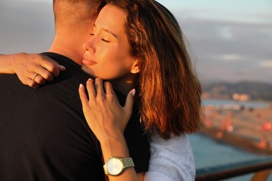 Photo of Happy young couple hugging on sea embankment