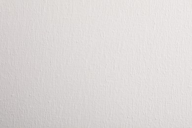 Photo of Blank white canvas as background, closeup view