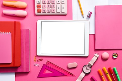 Photo of Modern tablet, calculator and stationery on pink background, flat lay. Space for text