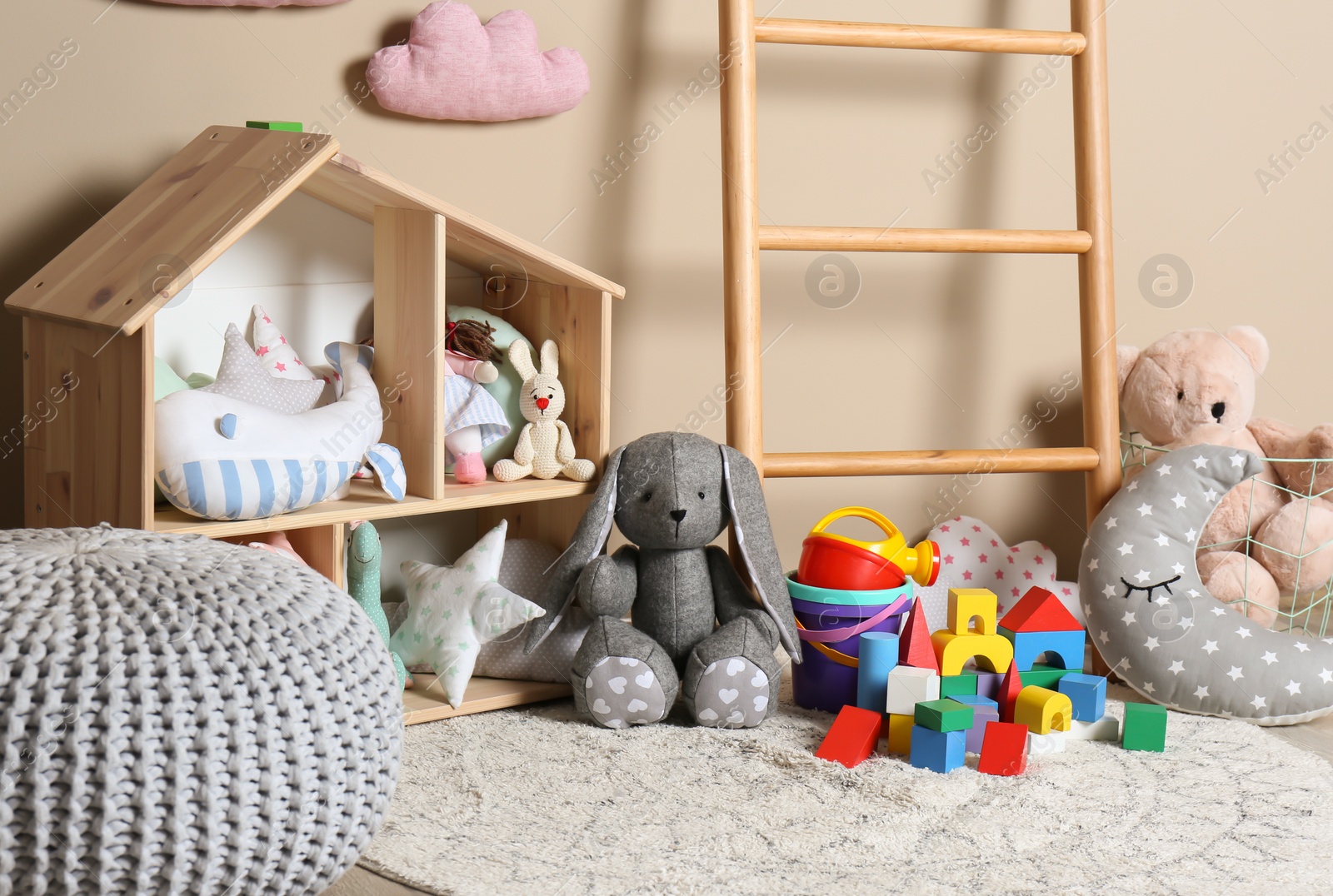 Photo of Different child toys on floor against color wall