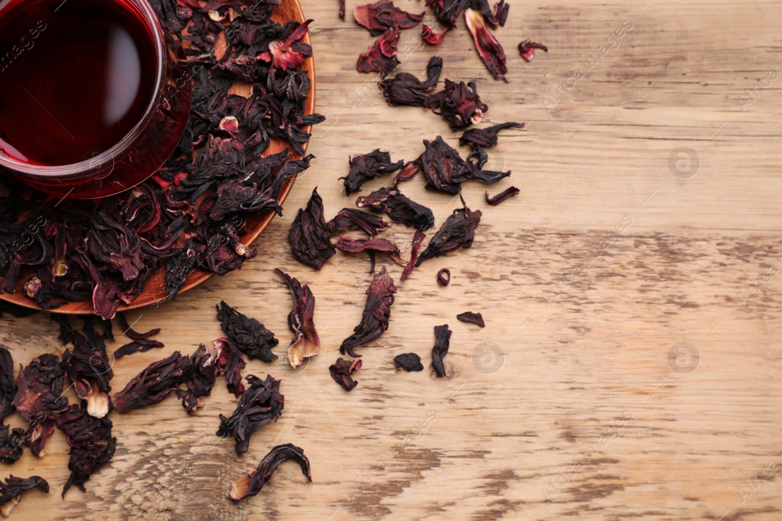 Photo of Fresh Hibiscus tea on wooden table, flat lay. Space for text