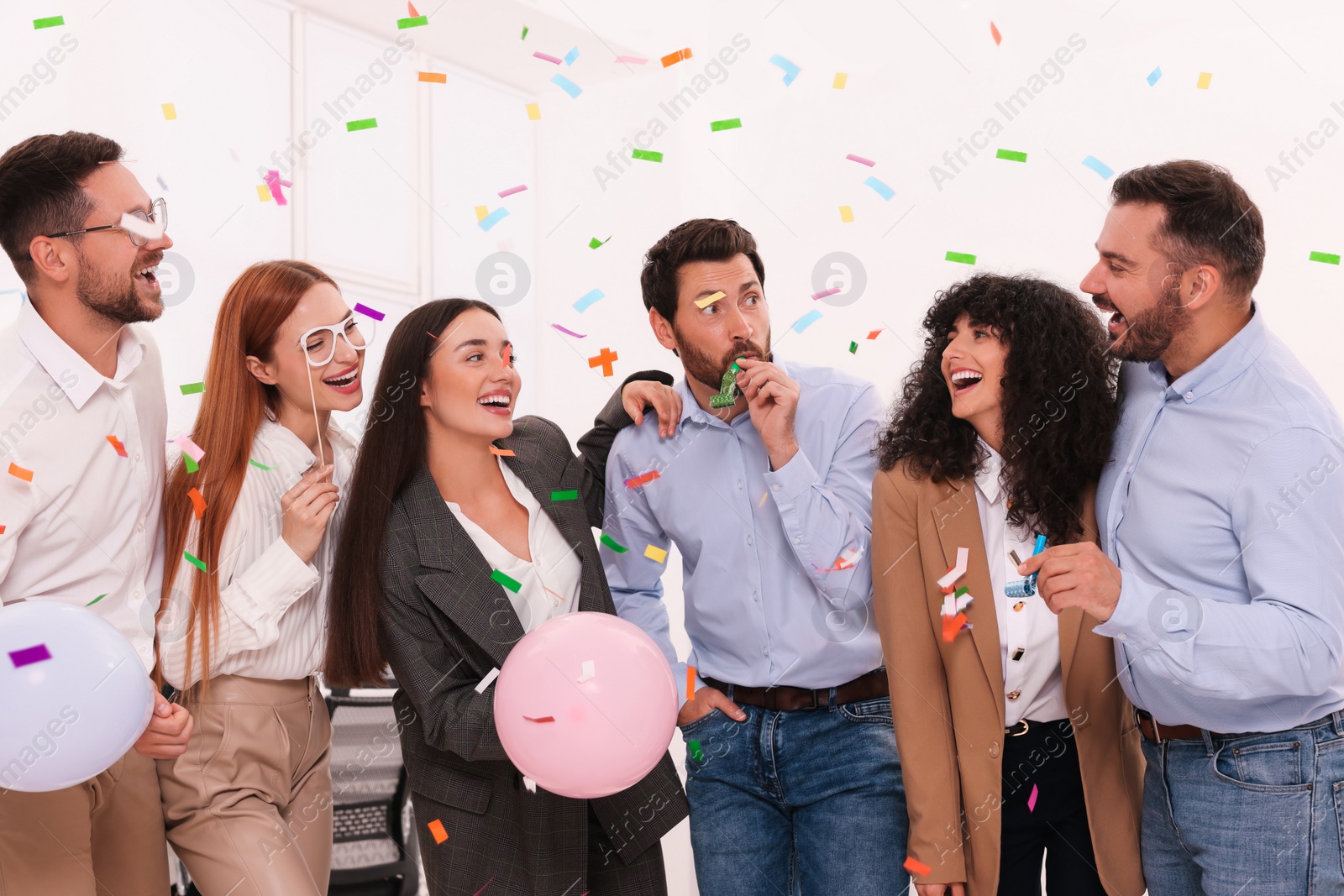 Photo of Coworkers having fun during office party indoors