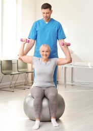 Physiotherapist working with patient in clinic. Rehabilitation therapy