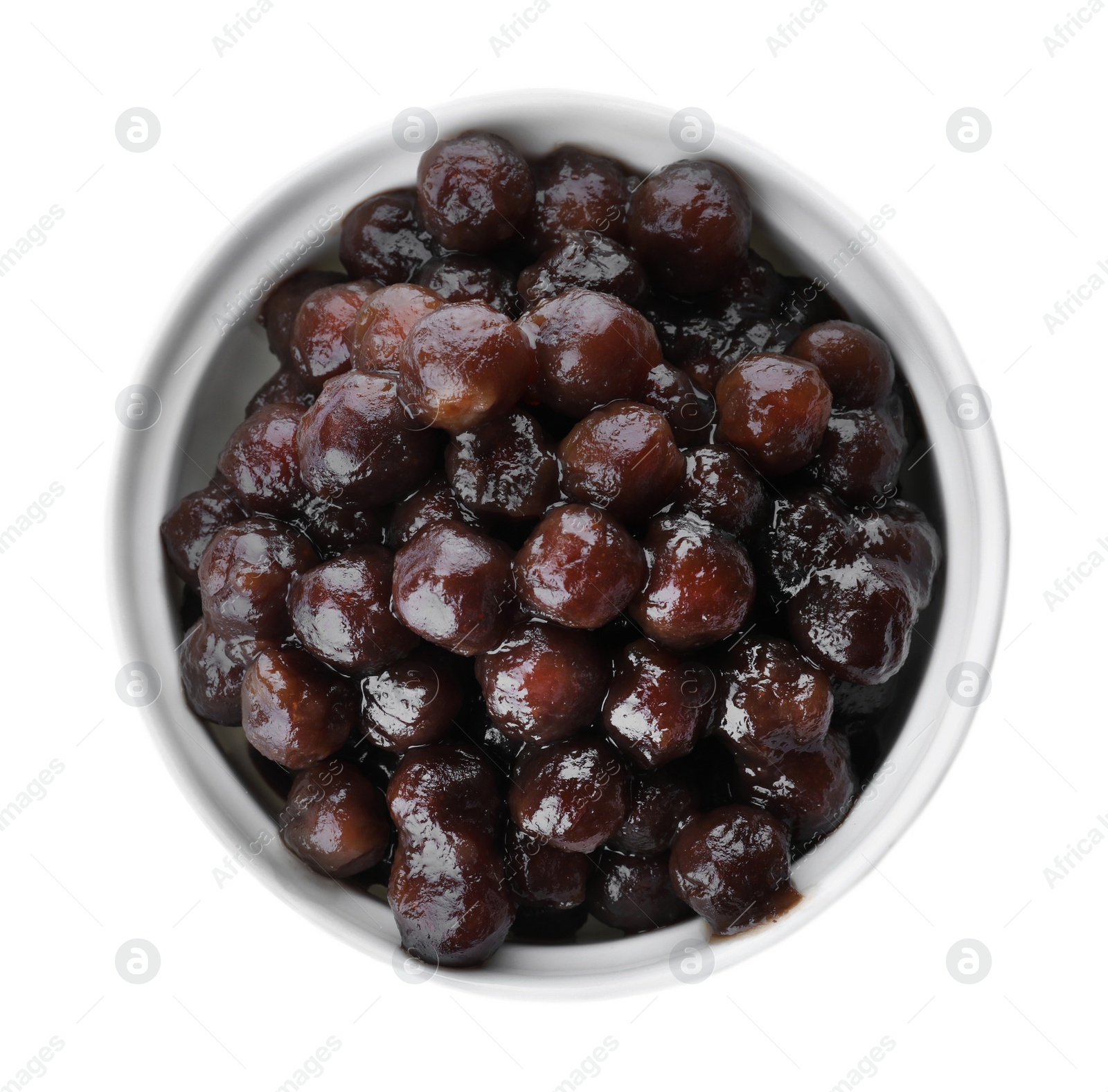 Photo of Tapioca balls for milk bubble tea in bowl isolated on white, top view