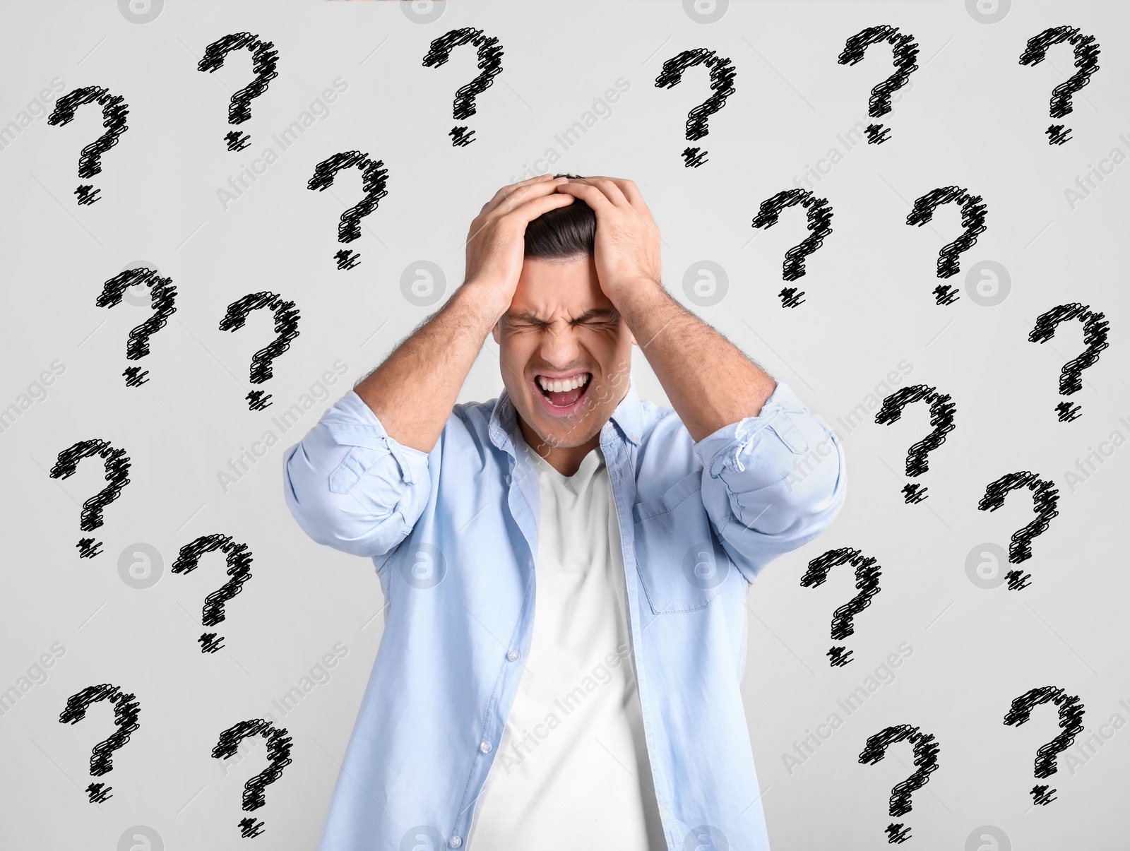 Image of Amnesia. Stressed man and question marks on light background