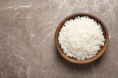 Photo of Plate of tasty cooked rice on color background, top view. Space for text