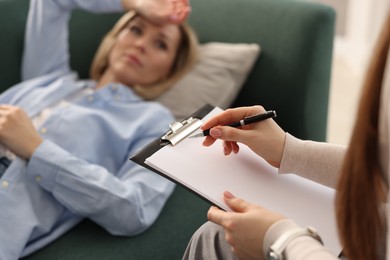 Photo of Professional psychotherapist working with patient in office